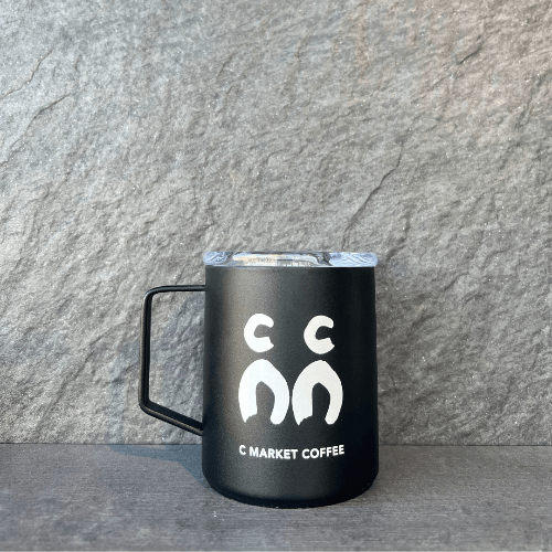 The C Market Coffee Camper Mug (12oz) combines style and practicality for your daily coffee routine. Made with durable materials, this mug features a sleek design with a push-on lid and a no-sweat exterior to keep your hands dry. Its 12oz capacity is perfect for holding your favorite coffee while fitting comfortably in your cup holder. BPA-free and globally-minded, it's the ideal companion for enjoying your coffee on the go, whether you're at home, work, or exploring the outdoors.