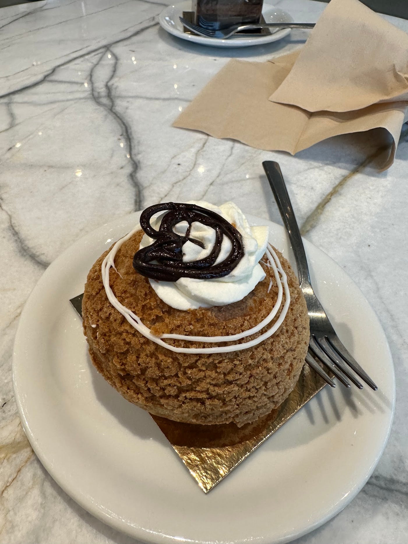 An open and breathable space to relax, enjoy coffee and desserts, with a great ambiance. The coffee was good, and the Cream Puff and Chocolate Cake were delightful, with the Cream Puff having the perfect level of sweetness. A cool and open place to hang out and chill.