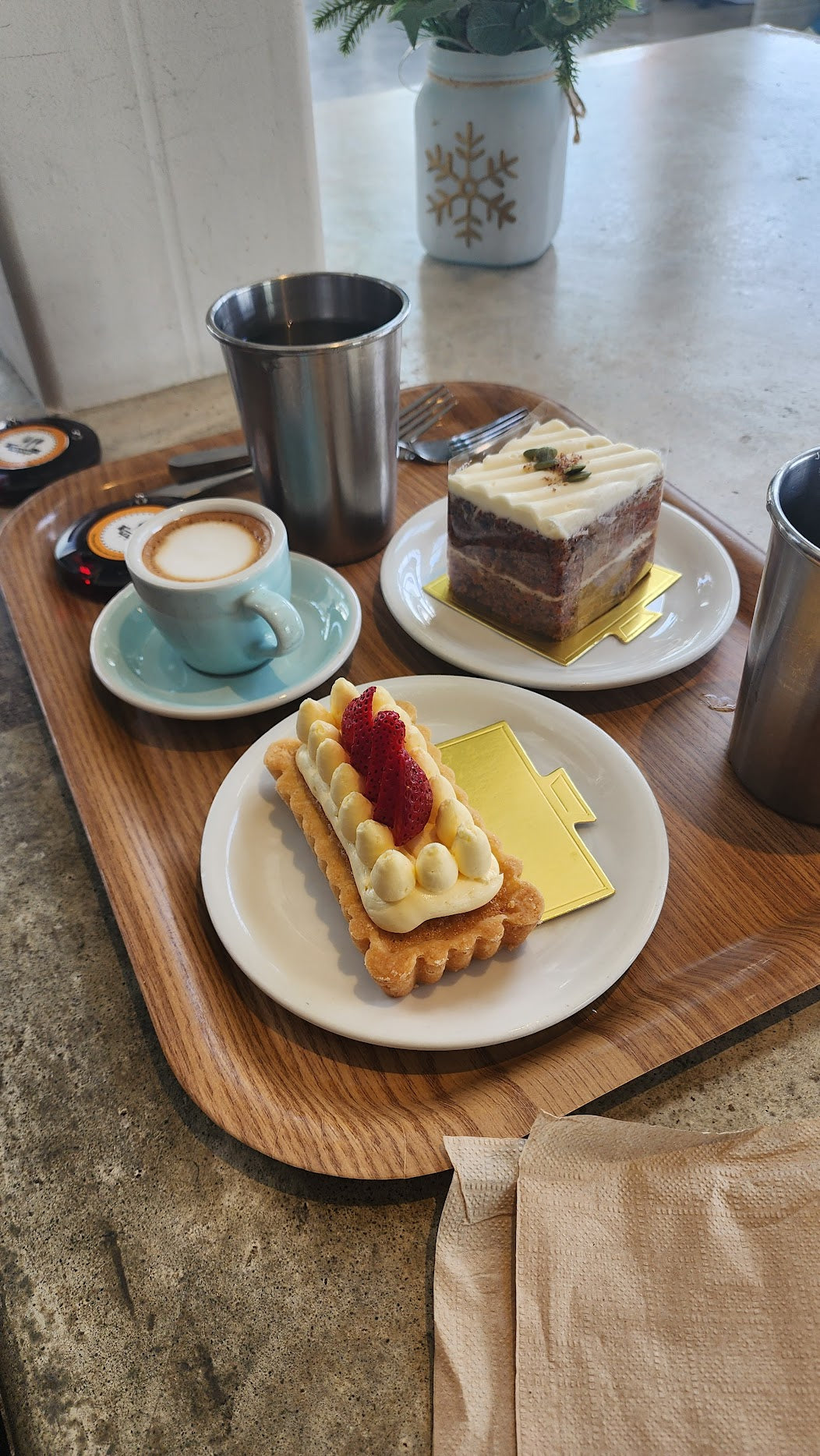 A spacious café at C Market Coffee with a variety of pastry options and high-quality coffee, loved by a customer who discovered the spot by chance.