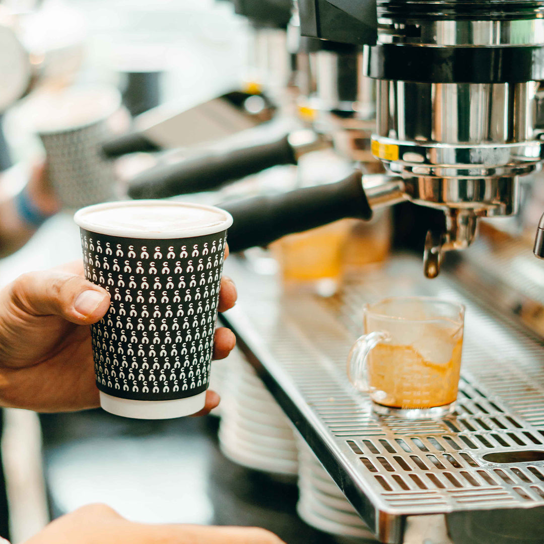 A barista skillfully preparing a cup of coffee, demonstrating the expertise provided by C Market Coffee's consulting team for new café owners.