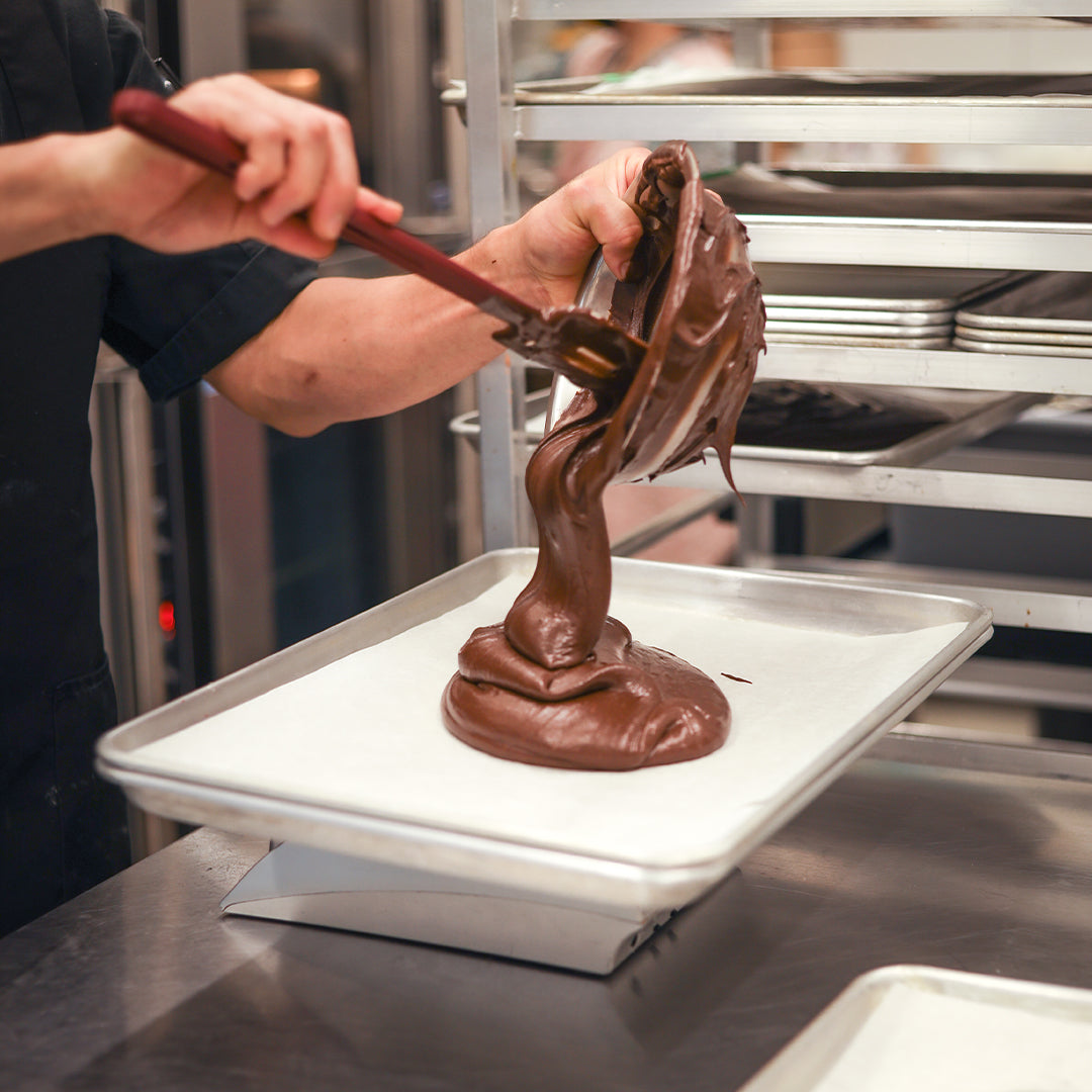 A close-up of rich chocolate ingredients being carefully prepared, showcasing the attention to detail in crafting customized orders that meet specific business needs, with an emphasis on high-quality ingredients for creating delightful chocolate-based products.