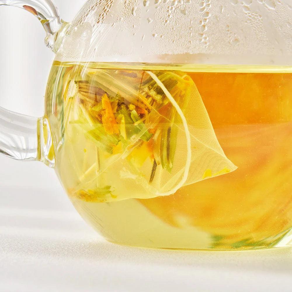 A close-up view of a glass jar filled with vibrant, flower-shaped tea sticks. The delicate tea sticks are arranged inside the transparent jar, showcasing their intricate craftsmanship and natural colors. The jar is topped with a simple lid, and the details of the tea sticks are clearly visible, emphasizing the quality and uniqueness of the product. The background is soft and blurred, keeping the focus on the jar and its contents.