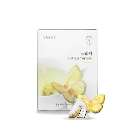 Chrysanthemum Butterfly Teabag set with three individually wrapped tea bags, each featuring a delicate butterfly-shaped holder that rests elegantly on the edge of a glass. The tea is handcrafted in Korea with natural ingredients, offering a soft and soothing taste. Chrysanthemum tea, known for its light, floral flavor, is caffeine-free and perfect for tea beginners. The design adds a whimsical and elegant touch to the tea-drinking experience, with no food additives used to ensure a pure and natural flavor.