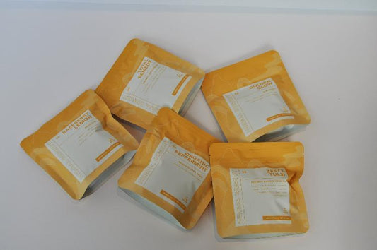 Herbal Remedy Teas from C Market Coffee, including five wellness blends: Total Remedy with Turmeric and Fennel for joint relief, Golden Glow with Ginger and Turmeric for skin health, Zesty Tulsi with Ginger and Tulsi for immunity, Organic Peppermint for nausea relief and focus, and Raspberry Lemon for a refreshing fruity blend. All teas are rooibos-based and available in 50g packs, offering natural flavors and health benefits.