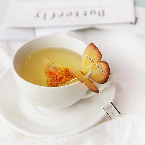 The Marigold Butterfly Teabag by KKOKDAM is a charming, handcrafted tea with a butterfly-shaped holder that rests delicately on the edge of your cup. Filled with Marigold flowers, this caffeine-free tea boasts a sweet, floral aroma and a light, soothing flavor. Sourced from Korea, it’s made with natural ingredients, ensuring a pure and relaxing tea experience. The vibrant yellow and orange colors of Marigold make it as visually appealing as it is refreshing, perfect for a tranquil moment of enjoyment.