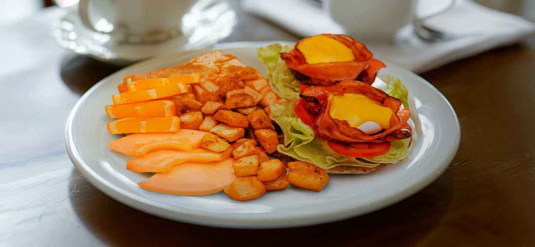 A plate of mouthwatering egg benedicts at C Market Coffee, featuring perfectly poached eggs atop toasted English muffins, layered with fresh ingredients and drizzled with creamy hollandaise sauce. A must-try specialty known for its exceptional flavor and presentation.