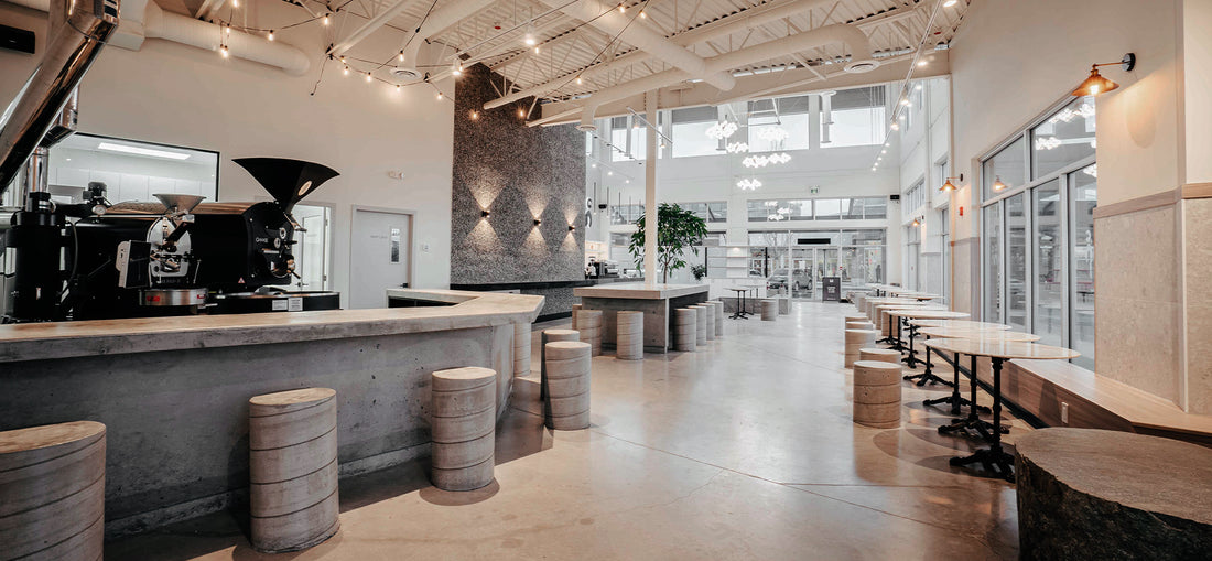 Bright and airy interior of C Market Coffee, featuring large windows that flood the space with natural light, creating a warm and inviting atmosphere for customers to relax and enjoy their coffee.