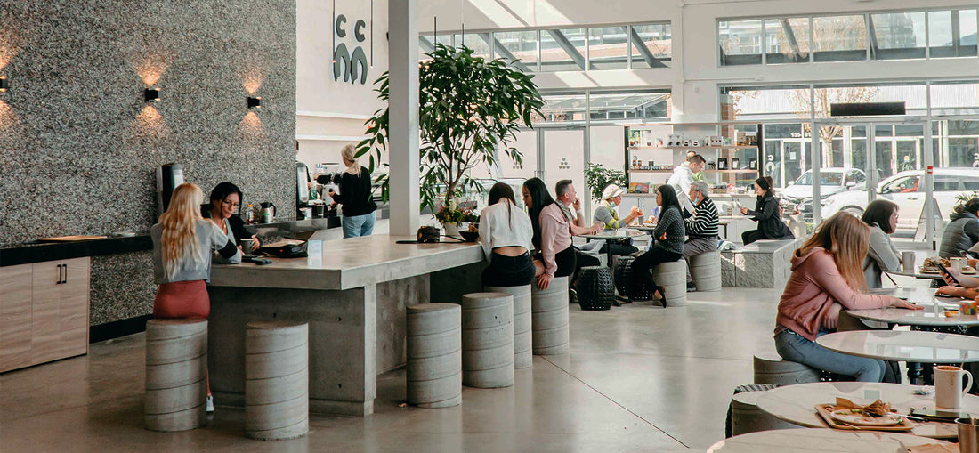 Stunning interior of C Market Coffee, featuring a modern and inviting design with elegant decor, spacious layout, and plenty of natural light, creating a warm and welcoming atmosphere for customers to enjoy their coffee and meals.