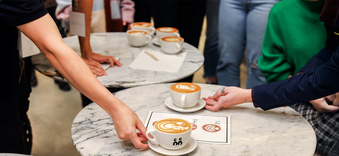 A dynamic scene at C Market Coffee during a coffee competition, with skilled baristas showcasing their expertise, competing in latte art, espresso brewing, and other coffee-related challenges, creating a lively and engaging atmosphere for both participants and spectators.
