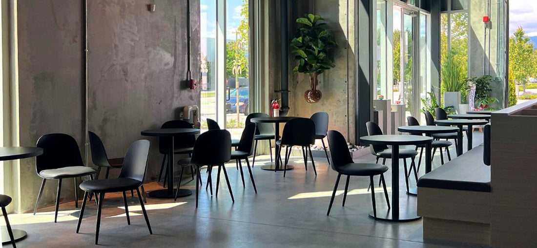 A bright and airy space at C Market Coffee in Pitt Meadows, featuring large windows that allow natural light to flood the café, creating a warm and inviting atmosphere for customers to enjoy their coffee and meals.